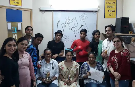 Students enjoying a fun cosplay party inside the classroom with creative costumes.
