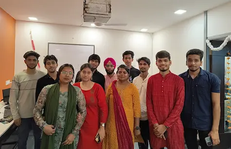 Students in colourful ethnic wear celebrating a cultural event in class